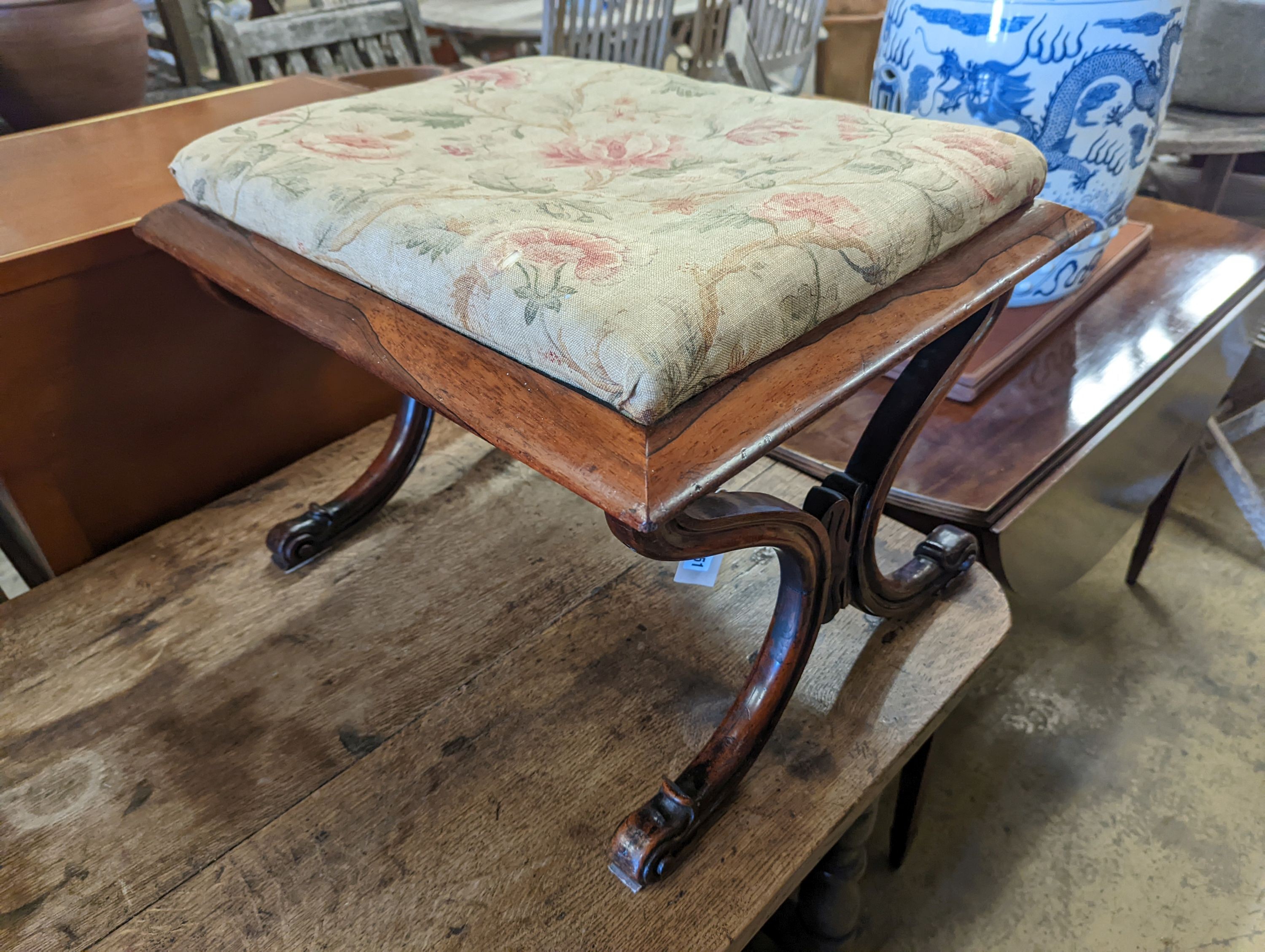An early Victorian rectangular rosewood X frame dressing stool, length 59cm, depth 48cm, height 42cm